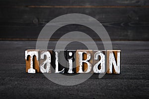 Taliban. Afghanistan's political and culture. White wooden letters on a dark wooden background photo