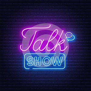 Talk show neon sign on brick wall background.