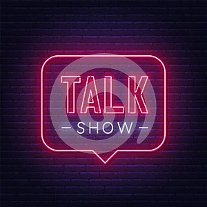 Talk show neon sign on brick wall background.