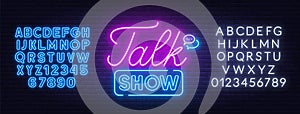 Talk show neon sign on brick wall background.