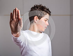 Talk to the hand gesture by blurred Caucasian teen