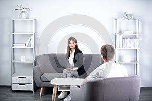 Talking business people. Young business couple wear casual clothing relaxing in office working with computer laptop.