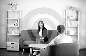 Talking business people. Young business couple wear casual clothing relaxing in office working with computer laptop.