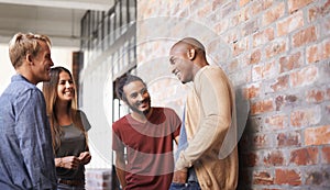 Talking, laughing and college friends or students in a hallway for a happy discussion. Group of diversity men and a