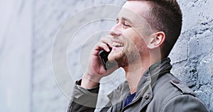 Talking man, laughing or phone call by city wall background for joke, story or university conversation. Smile, happy or