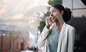 Talking on a phone, communication and networking with a young, confident and ambitious young business woman on a balcony