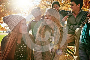 Talking, teenagers and friends outdoor in park for relaxing day on summer vacation of semester break, together and happy photo