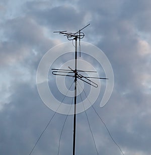 A tall antenna with a black pole and a black antenna on top of it