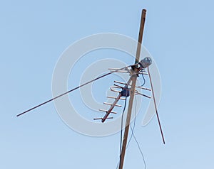 A tall antenna is on a pole