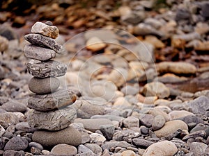 Tall balance stone tower against organic nature background. Concept patience at reaching your target
