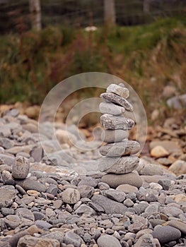 Tall balance stone tower against organic nature background. Concept patience at reaching your target