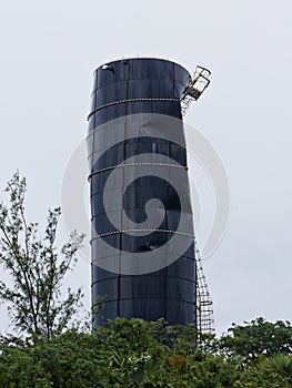 Tall blue water tank dented by strong winds at Exuma Cays