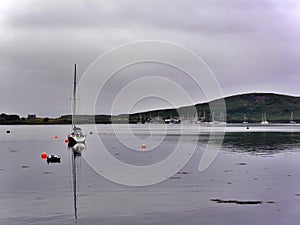 Tall boat with reflection in bay early morning, Oban, Scotland