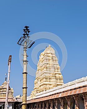 Tall, brass lamp post in front of Virupaksha temple, Hampi, Karnataka,India