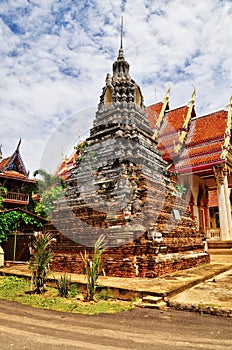 Tall brick chedi of unusual pyramidal design in Wat Muang  , Singburi , Thailand