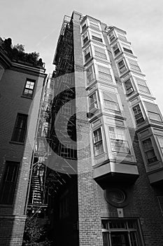 Tall building with fire escape and bay windows