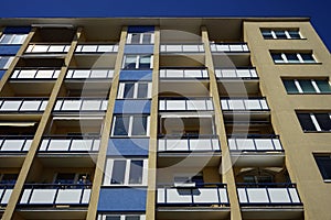 a tall building has windows and balconies on both sides