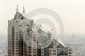 A tall building with a lot of windows and a triangular roof photo