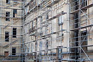 Tall building under construction with scaffolds. Scaffold. Construction Scaffoldings.