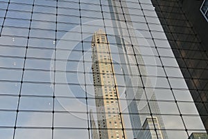 Buildings reflecting on a glass walled building photo