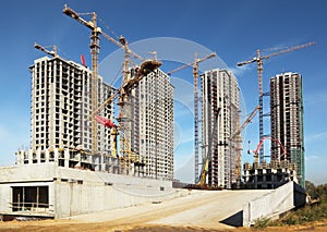 Tall buildings under construction with cranes