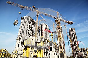 Tall buildings under construction and cranes