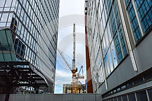 The tall business skyscrapers and the construction crane i