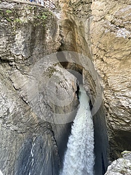 Tall canyon walls with river water rushing through it