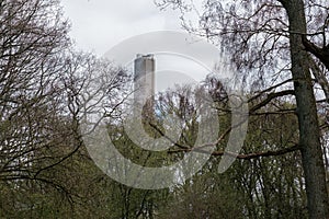 Tall cocrete chimney visible from nearby park in sweden