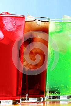 Tall cola, creme soda and raspberry soda fizzy drinks photo