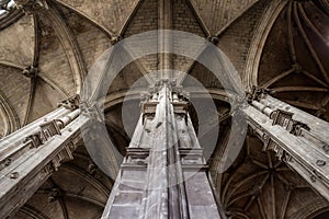 Tall columns and beautifully ornate ceiling in the gothic church Saint Eustache in Paris