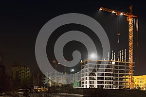 Tall cranes and brick buildings under construction