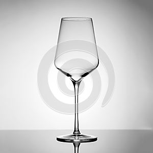 A tall glass made of thin glass on a long stem