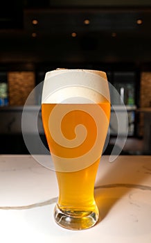 Tall Glass of Refreshing Ice Cold Beer with a Good Head of Foam