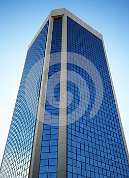 A Tall Glass Tower Reflects the Sky photo