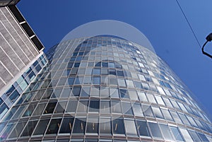 A tall, glass-walled building in the center of the city photo