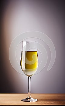 A tall glass of white wine on a wooden surface isolated close-up