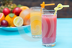 Tall glasses of healthy fresh squeezed fruit juice