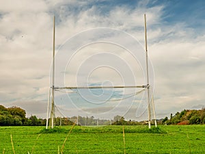 Tall goal post on training pitch for Irish National sport camogie, hurling, rugby and Gaelic football Nobody. Cloudy sky. Popular