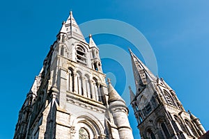 The tall Gothic spire of an Anglican church in Cork, Ireland. Neo-Gothic Christian architecture. Cathedral Church of St Fin Barre