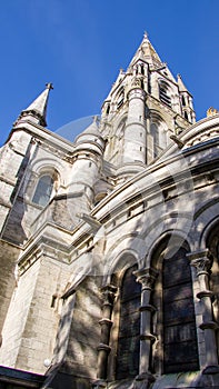 The tall Gothic spire of an Anglican church in Cork, Ireland. Neo-Gothic Christian religious architecture. Cathedral Church of St