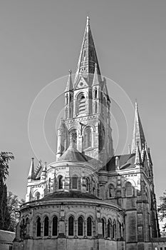 The tall Gothic spire of an Anglican church in Cork, Ireland. Neo-Gothic Christian religious architecture. Cathedral Church of St