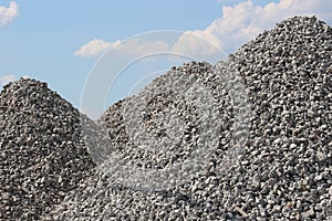 Tall Gravel Rock Piles with Bright Blue Sky