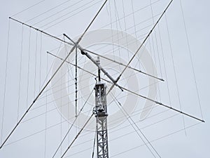 A tall ham radio antenna with some snow on it