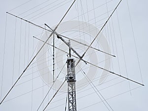A tall ham radio antenna with some snow on it photo