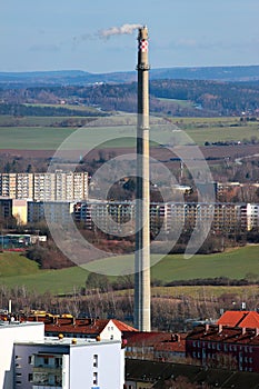 Tall industrial smokestack pipe in a city, Germany