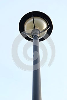 Tall light pole on blie sky