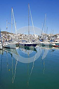 Tall luxury boats and yachts moored in Duquesa port in Spain on