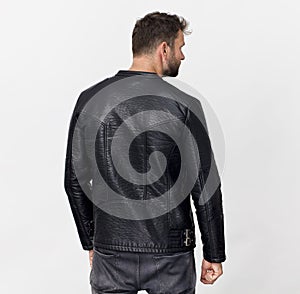 Tall man back portrait in black jacket, isolated on white