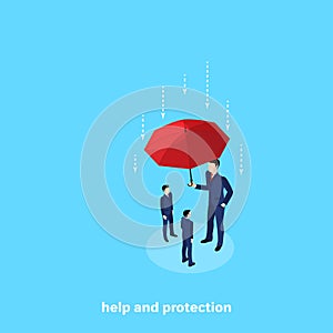 A tall man in a business suit is holding an umbrella over other people protecting them